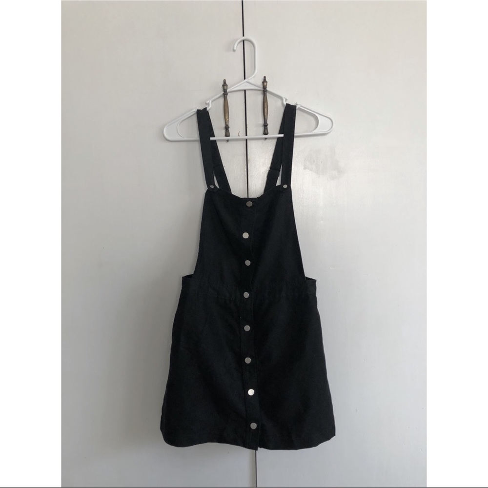 Snap-front black overall skirt/dress.